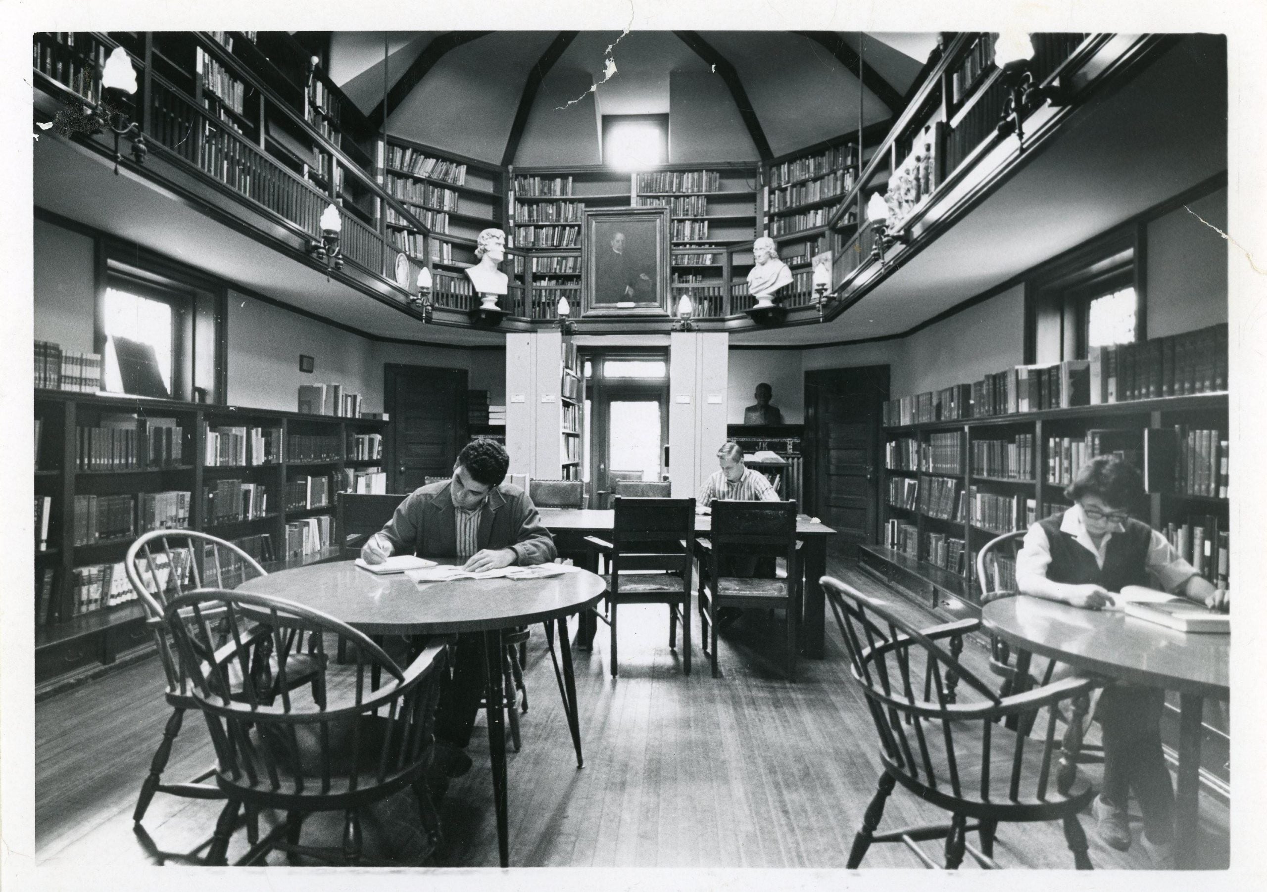 Black-and-white photograph of students and a woman reading in the Joseph Krauskopf Memorial Library